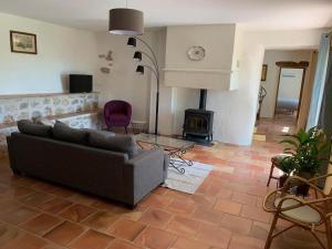 a living room with a couch and a fireplace at Mas de la clue - 4 personnes in Figanières