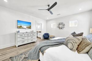 a bedroom with a bed and a dresser at Emerald Escape in Destin, Miramar Beach! 4BR, 4BA, 1st Floor Bedroom, Sleeps up to 14, Golf Cart Included, Pool, Pet Friendly, Private Deeded Beach Access & Gated Community! in Destin +22 photos