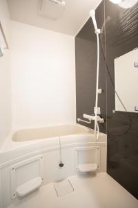 a white bathroom with a sink and a shower at H-1ビル 301 hiroshima in Hiroshima +3 photos