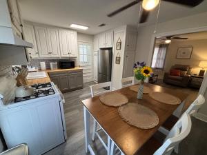 a kitchen with a table with a vase of flowers on it at Close-to-Everything Midtown Cottage in Hattiesburg