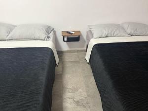 two beds sitting next to each other in a room at Punta Lobos in Reynosa +1 photo