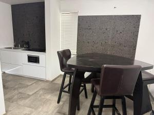 a black dining room table and chairs in a kitchen at Punta Lobos in Reynosa