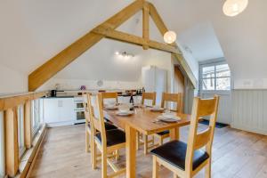 a kitchen and dining room with a wooden table and chairs at 3 Bed in Totnes oc-bcplym in Broadhempston