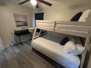 a bedroom with a bunk bed and a piano at Close-to-Everything Midtown Cottage in Hattiesburg +49 photos