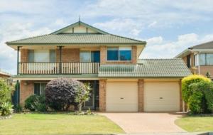 a large house with a balcony and a garage at Beach Street Stay in Harrington