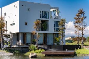 a house on the water with a dock at Sugar House in Wujie