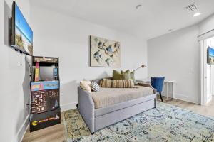 a living room with a couch and a tv at Emerald Escape in Destin, Miramar Beach! 4BR, 4BA, 1st Floor Bedroom, Sleeps up to 14, Golf Cart Included, Pool, Pet Friendly, Private Deeded Beach Access & Gated Community! in Destin