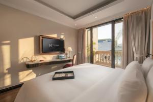 a hotel room with a bed and a large window at Heritage Ham Long Hotel and Spa in Hanoi