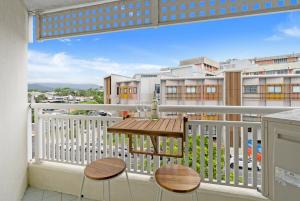 a balcony with two chairs and a table on it at Northshore Palms Apartment in Cairns North +35 photos