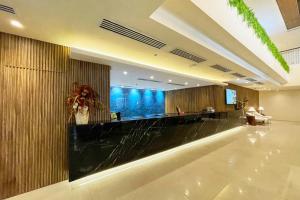 a lobby with a bar in a hotel at Elijah Hotel Dasmarinas City Cavite in Dasmariñas