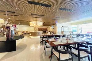 a dining room with tables and chairs in a restaurant at Elijah Hotel Dasmarinas City Cavite in Dasmariñas