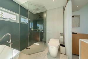 a bathroom with a toilet and a glass shower at Sugar House in Wujie