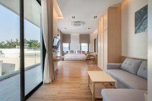 a living room with a couch and a bed at Mövenpick Pool Villa6BR-NEW2025- in Na Jomtien