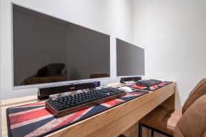 a desk with a computer monitor and a keyboard and mouse at 루엠호텔안산 in Ansan +14 photos