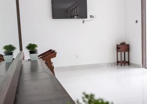 a hallway with benches and potted plants at Ophelia in Diyatalawa
