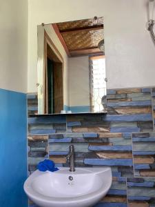 a bathroom with a sink and a mirror at Wallace and Gromit's in Siquijor