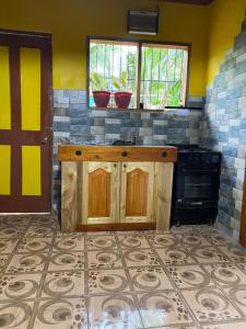 a kitchen with a counter and a stove in it at Wallace and Gromit's in Siquijor