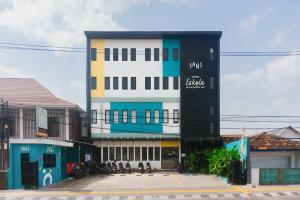 a tall building withcriptions on the side of it at Sans Stay Eskole Lampung in Geruntang