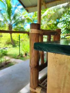 a wooden bench in a park with trees in the background at Rose Apartments in Anda