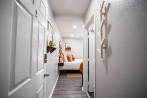 a hallway leading to a bedroom with a bed at BOHO-MOD STUDIO APARTMENTs in Ferris