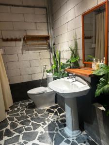 a bathroom with a toilet and a sink at Hong Ly House in Vĩnh Hy