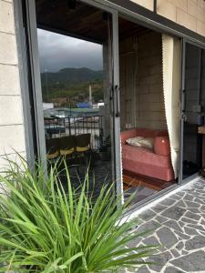 a screened in porch with a couch on a patio at Hong Ly House in Vĩnh Hy