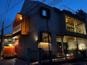 a brick building with windows and a balcony at Hong Ly House in Vĩnh Hy