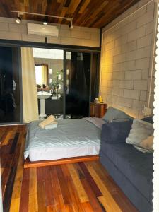 a bed and a couch in a living room at Hong Ly House in Vĩnh Hy