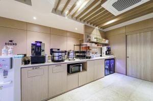 a kitchen with a counter top with a coffee maker at Daegu Hound Hotel Dongchon Amusement Park in Daegu