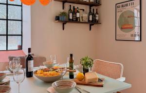 a table with a bowl of cheese and wine bottles at 2 Bedroom Nice Apartment In Glemmingebro in Glemminge