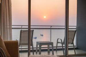 a room with two chairs and a table on a balcony at Large 3BR Veranda Pattaya Direct Beach Access in Jomtien Beach