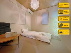 a room with a bed and signs on the wall at Sankando Villa Hotel in Fujikawaguchiko