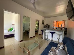 a living room with a couch and a table at Sloth House - Centric 2BR with shared pool in Puerto Viejo