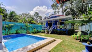 a house with a swimming pool in the yard at Casa Caribe Azul - Playa Negra 2BR with AC and pool in Puerto Viejo