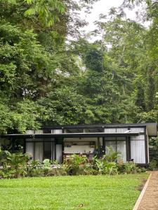 a modern house in the middle of a garden at Sharka House - Playa Negra 2BR with pool & AC in Puerto Viejo