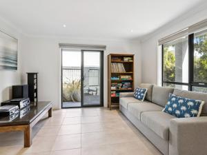 a living room with a couch and a tv at Azura on Gordon in Mornington