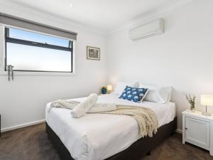 a bedroom with two beds and a window at Azura on Gordon in Mornington