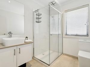 a bathroom with a glass shower and a sink at Azura on Gordon in Mornington +12 photos