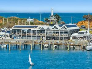 a sailboat in the water in front of a marina at Azura on Gordon in Mornington