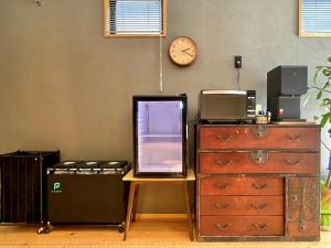 an office with a desk and a clock on the wall at hatago STAY Shinmachi in Nakatsugawa