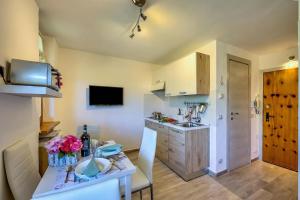 a small kitchen with a table and a sink at Studio La Borracina Mountain View - Happy Rentals in Sauze dʼOulx