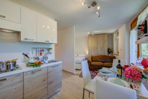 a kitchen and living room with a table and chairs at Studio La Borracina Mountain View - Happy Rentals in Sauze dʼOulx