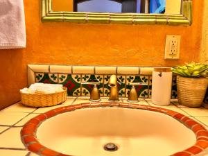 a sink in a bathroom with a mirror at Posada del Cortes in Loreto +144 photos
