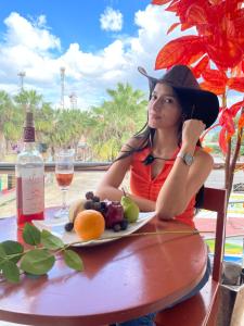 a woman sitting at a table with a plate of fruit at Irigoin Hospedaje in Nueva Cajamarca +16 photos