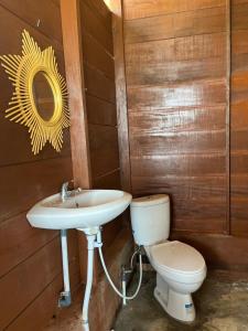 a bathroom with a sink and a toilet at Dico Surf Point- Surf Lodge in Simeulue in Lasikin