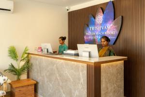 two women sitting at a counter with their laptops at Trishvam Palolem Beach Resort in Canacona