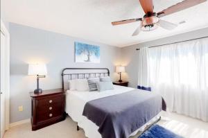 a bedroom with a bed and a ceiling fan at Pointe Royale's Relaxation Pointe in Branson +38 photos
