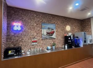 a bar in a restaurant with a brick wall at Hotel M&M Soma in Soma