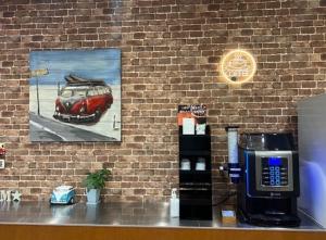 a brick wall with a picture of a car on the wall at Hotel M&M Soma in Soma +4 photos