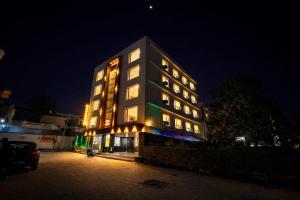 a tall building with lights on it at night at Hotel Royal Dot, Haridwar in Haridwār